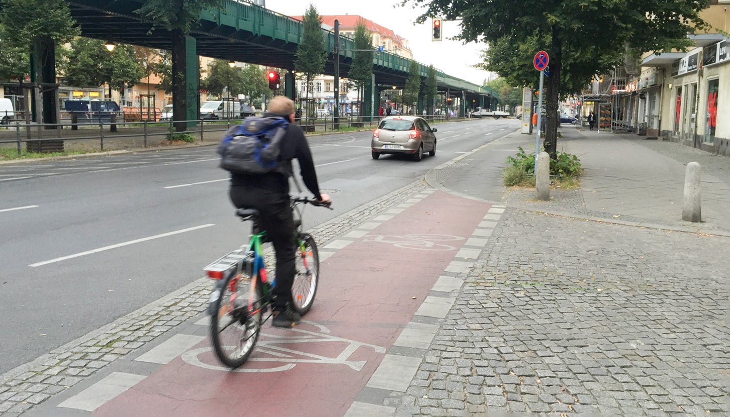 アスファルト舗装の車道（左）と、石畳の歩道。中央の赤く塗られた部分は自転車道。ドイツ・ベルリンにて筆者撮影